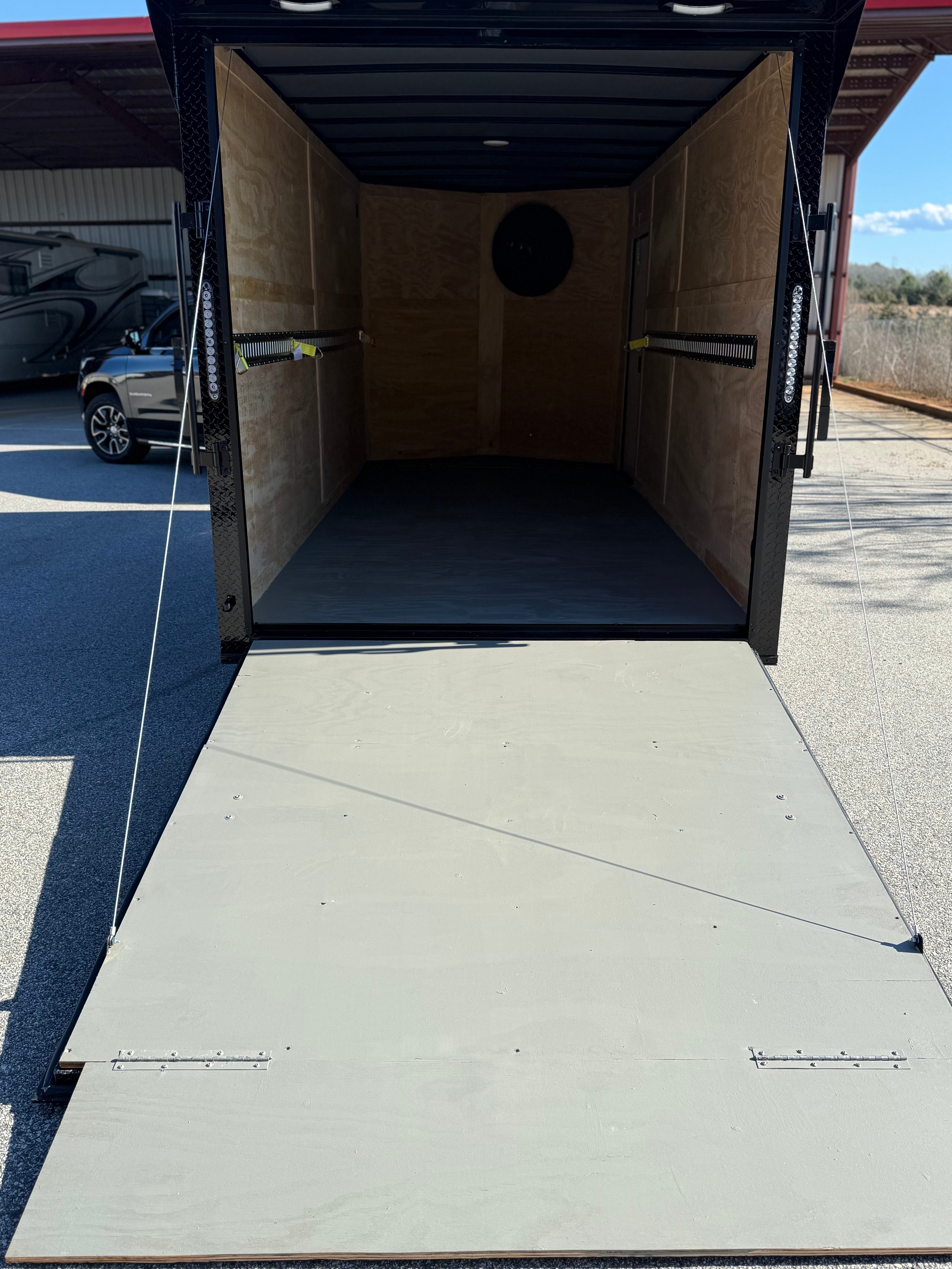 2026 Cargo United 7x16ft enclosed trailer — interior view with rear ramp open and LED lighting